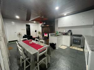 a kitchen with a dining table and a kitchen with a stove at RLJ Beach House in Naval