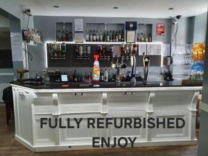 a bar with a fully refurbished enjoy sign on it at THE COASTAL INN ACCOMMODATIONs in Cellardyke