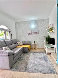 a living room with a couch and a tv at Lovely Apartament Taidia in Maspalomas
