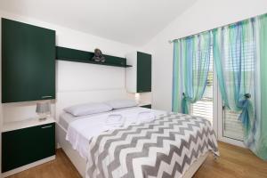 a bedroom with a large bed and a window at Apartments with parking space Punat, Krk - 20553 in Punat