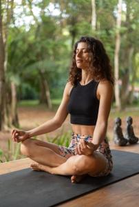 a woman sitting in a yoga pose at Four Monkeys Eco Lodge - Jungle & Beach in Cabo Matapalo