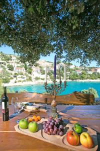 a table with a bunch of fruit and candles on it at Villa Hera Sevid in Sevid