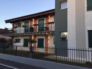 an apartment building with balconies and a fence at Albergo La Quiete in Oppeano