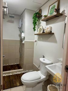 a bathroom with a toilet and a sink at Le Amour Room Stay - Smdc Cheer Residences in Marilao +5 photos