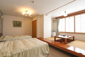 Postel nebo postele na pokoji v ubytování 赤湯温泉 丹泉ホテル
