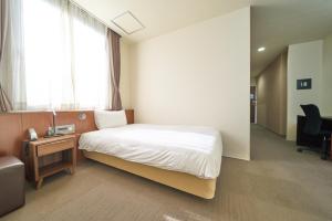 Postel nebo postele na pokoji v ubytování Hotel Tohkai