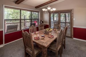 a dining room with a wooden table and chairs at Amazing Place in Ruidoso