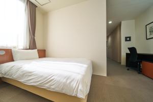 Postel nebo postele na pokoji v ubytování Hotel Tohkai