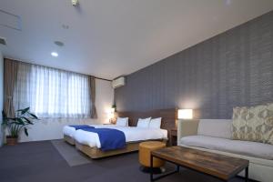 Postel nebo postele na pokoji v ubytování Hotel Tohkai