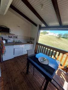 a kitchen with a table and a large window at Kaz an nou in Saint-Louis +1 photo