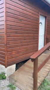 a wooden bench sitting on a wooden deck at Kaz an nou in Saint-Louis
