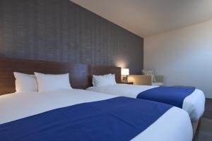 Postel nebo postele na pokoji v ubytování Hotel Tohkai