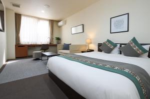 Postel nebo postele na pokoji v ubytování Hotel Tohkai