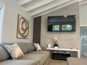 a living room with a couch and a flat screen tv at Blackbeard Retreat in Little Torch Key