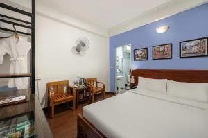 Postel nebo postele na pokoji v ubytování A25 Hotel - Đội Cấn 2