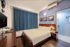 Postel nebo postele na pokoji v ubytování A25 Hotel - Đội Cấn 2