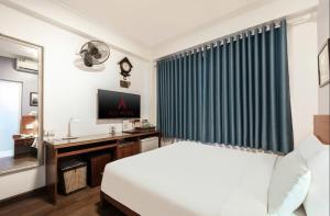 Postel nebo postele na pokoji v ubytování A25 Hotel - Đội Cấn 2