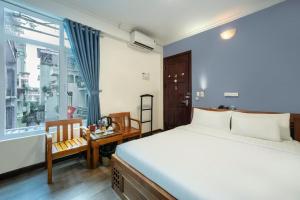 Postel nebo postele na pokoji v ubytování A25 Hotel - Đội Cấn 2