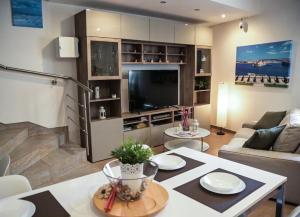 a living room with a couch and a tv at Giorgia House in Pieta