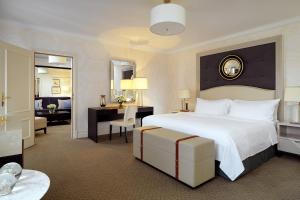 a hotel room with a large bed and a desk at Hotel Bristol, A Luxury Collection Hotel, Warsaw in Warsaw