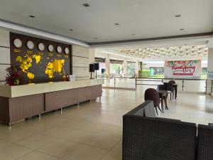a lobby with a waiting area with clocks on the wall at D&G City Haven in Mandaue City +3 photos