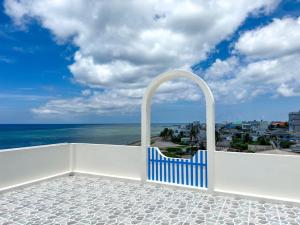 a blue and white gate on a balcony overlooking the ocean at Dứa Homestay in Cu Lao Thu +65 photos