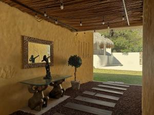a patio with a table and a picture on the wall at Habitacion Cerca del centro 1 in Tepoztlán