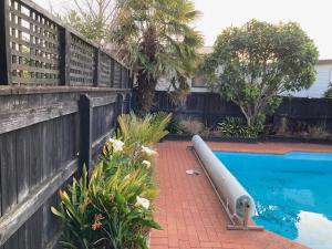 a swimming pool with a white tube next to a fence at 48, GROVE St in Nelson