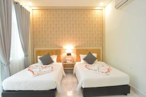 Sangkahak Mith Hotel客房内的一张或多张床位