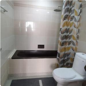 a bathroom with a toilet and a shower curtain at Seaview Regency Tanjung Tuan Apartment A7-4 in Pulau Burung +28 photos