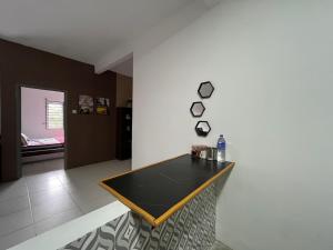 a dining room with a table on a wall at EL Homestay in Melaka