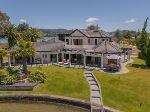 an aerial view of a house with a yard at Amalfi - Pauanui Holiday Home in Hikuai