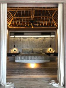 a bedroom with a large bed in a room at Sardine Beach Rote in Pulau Helihana