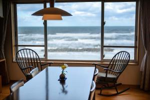 a dining room with a table and a view of the ocean at Ikkyu -Seaside Hotel- in Tsuruoka