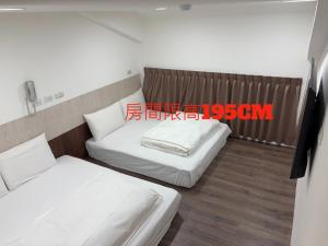 Postel nebo postele na pokoji v ubytování 安平商旅Choona Hotel Anping