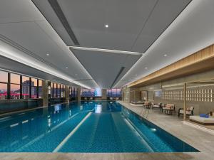 a large swimming pool in a building at Hilton Yuyao in Yuyao
