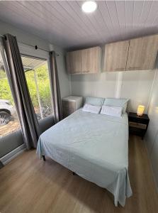 a bedroom with a bed and a large window at Villa Horizonte in Plazuela
