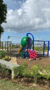 a playground in a park with a play equipment at Migs&Lucia NewNew House in Tagaytay and Caleruega in Calo +34 photos