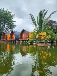 a resort with a reflection in a body of water at Chevilly Resort & Camp in Bogor