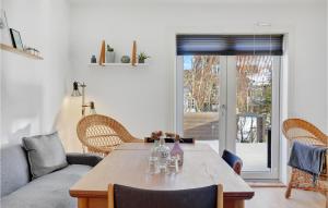 a living room with a table and a couch at 3 Bedroom Gorgeous Home In Gudhjem in Gudhjem