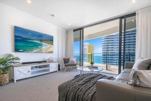 a living room with a view of the ocean at MEGA VIEWS at Oracle - level 32 in Gold Coast