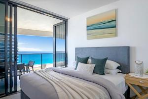 a bedroom with a large bed with a view of the ocean at MEGA VIEWS at Oracle - level 32 in Gold Coast +18 photos
