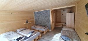a room with two beds in a wooden cabin at Štiavnička in Mýto pod Ďumbierom +34 photos