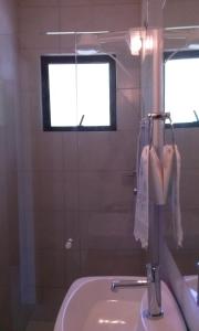 a bathroom with a sink and a mirror at Morada Colibri in Gamboa +26 photos