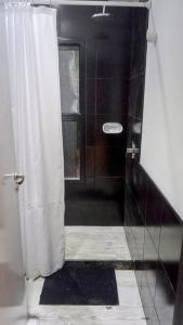 a bathroom with a shower with a shower curtain at Lapachos blco cabañas in Federación +8 photos