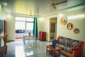 a living room with a couch and a table at Shree Varahi HomeStay in Tirupati