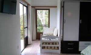a room with a chair and a large window at Morada Colibri in Gamboa
