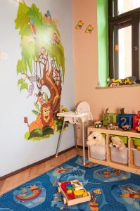 a childs room with a tree mural on the wall at Willa Marta Szczawnica in Szczawnica