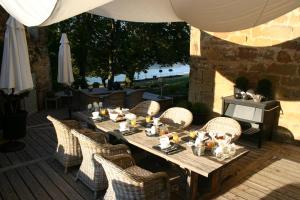 a wooden table with wicker chairs on a patio at Chateau de Lissac in Lissac-sur-Couze