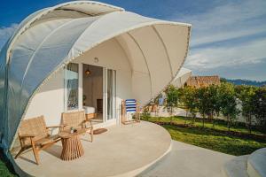 a round tent with a table and chairs on a patio at Onion Hill Glamping by Manara in Kintamani